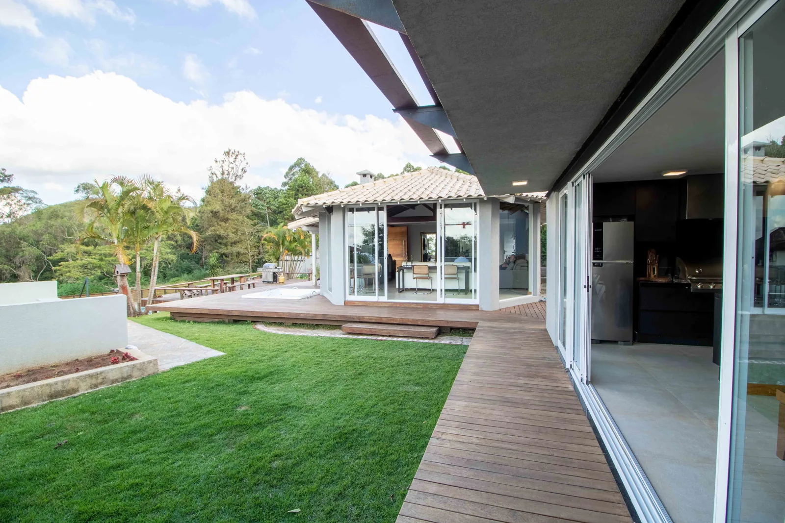 Open multi-panel sliding glass doors leading from a kitchen out to a deck
