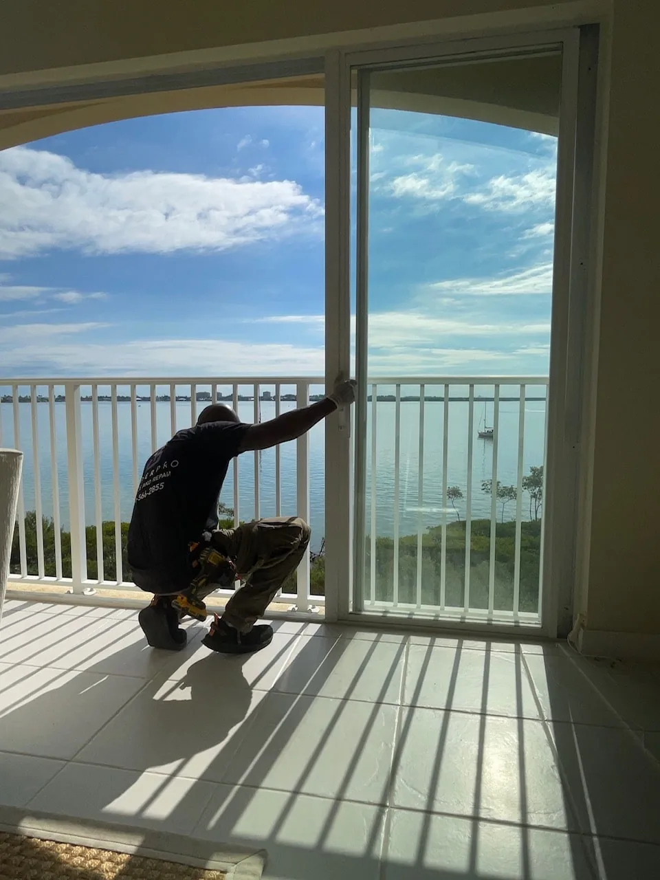 SliderPro owner Angelo Gordon fitting a sliding glass door on a Treasure Coast balcony