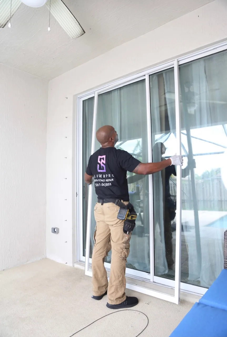 SliderPro technician checking the lock alignment on a sliding glass door