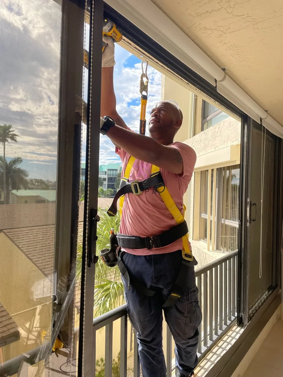 SliderPro technician performing maintenance on a high sliding door panel